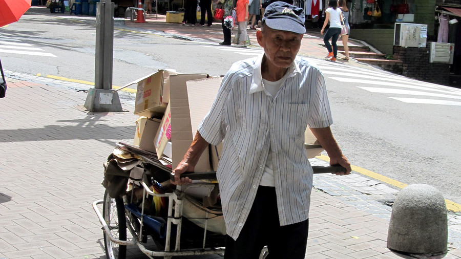 Old man pulling rubbish cart South Korea